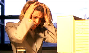 Woman holding head in hands