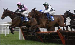 Gunther McBride leads the way in a hurdle race at Kempton