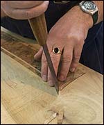 Worker cuts wood laminate into shape