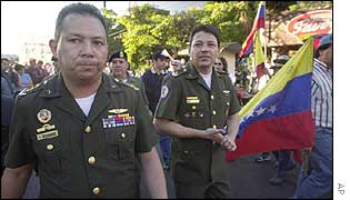 Army officers march with opponents of Hugo Chavez