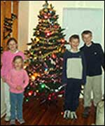 Allum kids around a Christmas tree
