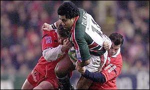 Leicester's Freddie Tuilagi is tackled by Jean-Philippe Grandclaude and Jean-Marc Aue of Beziers