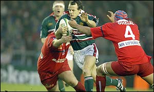 Leicester's Austin Healy is tackled by Karim Ghezal