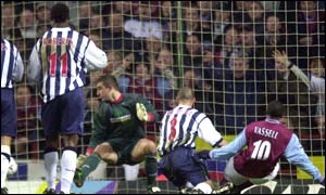 Aston Villa's Darius Vassell opens the scoring in the sixteenth minute as the West Brom players look on