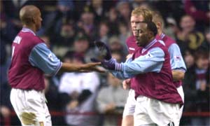 Villa players celebrate after a period of early pressure leads to a sixteenth-minute goal