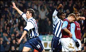 Jason Koumas celebrates as his twenty-ninth minute goal levels the score