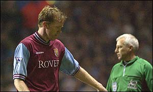 Steve Staunton walks off the pitch after he is red-carded, leaving Villa with only ten men for most of the second half