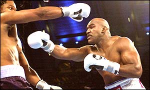 Chris Byrd moves out of the way of Holyfield's lunge