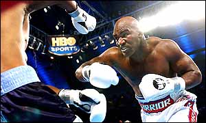 Evander Holyfield charges forward towards Chris Byrd