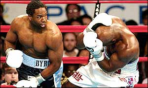 Evander Holyfield ducks for cover in the face of an onslaught from Chris Byrd