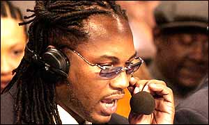 Lennox Lewis adjusts his ear piece before the fight