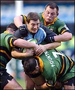 Cardiff fly-half Iestyn Harris is caught by the Northampton forwards