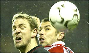 Stephane Henchoz and Kevin Phillips go for the ball in an aerial challenge