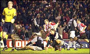 A dejected Liverpool defence look on after Michael Proctor seals victory for Sunderland with an 85th-minute winner