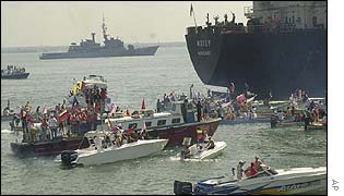 Opposition boats gather around the anchored tankers