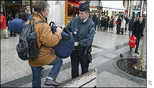 Police check a musician's bags on a Paris street
