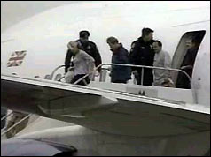 Rowdy passengers being escorted from the plane, January 1999