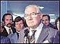 Prime Minister James Callaghan speaking into microphone at Heathrow airport