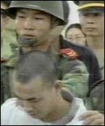 Chinese prisoner is led to execution by soldiers