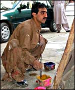 A billboard painter creates a hoarding