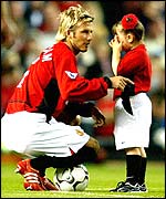 David Beckham with a young mascot 