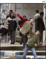 Palestinian youths throw stones at Israeli troops in Nablus 