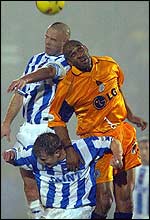 Leicester's Brian Deane jumps with Brighton defenders
