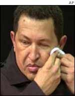 President Chavez wipes his face after a meeting with supporters on Wednesday