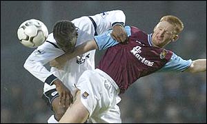 Bolton's Ricardo Garner battles in the air with West Ham's Steve Lomas