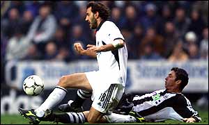 Newcastle's Gary Speed wins the ball from Sylvain Legwinski