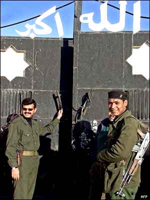 Iraqi soldiers closing the gates of a site inspected on Saturday