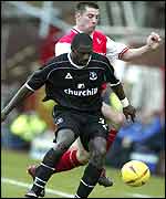 Darren Powell holds off Alan Lee of Rotherham