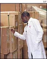 an election commission official inspects ballot boxes