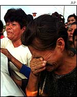 Distraught relatives wait for news outside the jail 