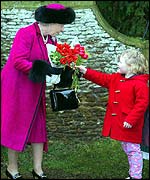 The Queen receives flowers after the service