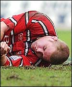 Gloucester captain Phil Vickery lies stunned after an accidental clash of heads with Tom Smith