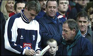 Birmingham City manager Steve Bruce signs autographs for fans