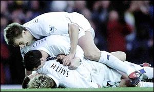 Milner disappears underneath his team mates after scoring 