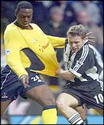 Spurs' Ledley King has his shirt pulled by Craig Bellamy