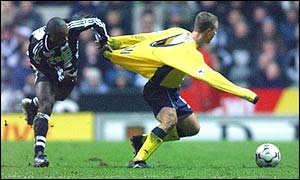 Newcastle's Lomana Tresor LuaLua grabs Chris Perry's shirt