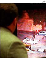 Brian Liddy looking at video