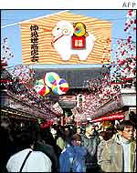 Visitors walk under the upcoming Year of the Sheep decorations at the Nakamise shopping mall near Sensoji temple in Tokyo