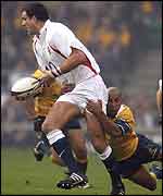England captain Martin Johnson beats the tackle of Australia's George Gregan