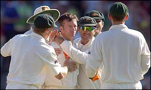 Australian captain Steve Waugh is congratulated by team mates after he has Key lbw in his first over