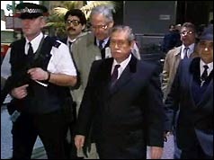 Diplomats flanked by armed police