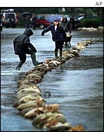 Children play on sandbags in Sint-Denijs Westrem, Belgium