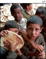 Boys receive food handouts in Karachi