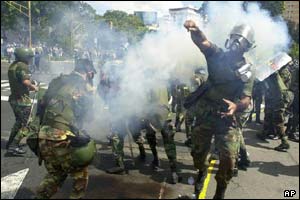 National Guard soldiers throw tear gas to prevent clashes between opposition protesters and supporters of President Hugo Chavez 