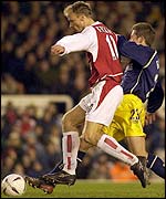 Bergkamp evades the challenge of Oxford's Steve Basham