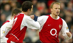 Dennis Bergkamp takes the plaudits from his team-mates after scoring against Oxford